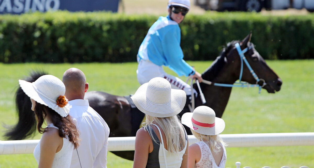 Neugieriger Jockey und elegante Zuschauer beim Fashion Raceday